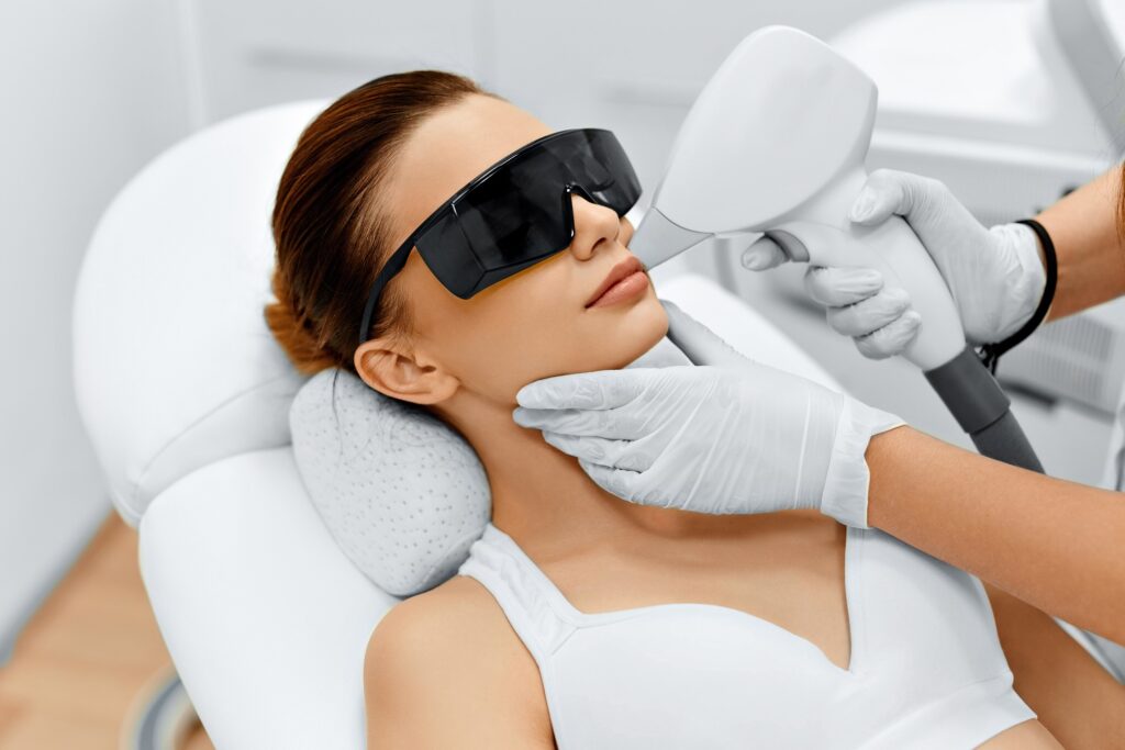 Face Care. Facial Laser Hair Removal. Beautician Giving Laser Epilation Treatment To Young Woman's Face At Beauty Clinic. Body Care. Hairless Smooth And Soft Skin. Health And Beauty Concept. | Timeless laser in Denver CO
